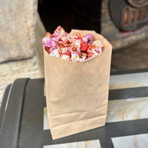 A bag of red and purple colored Outpost Popcorn